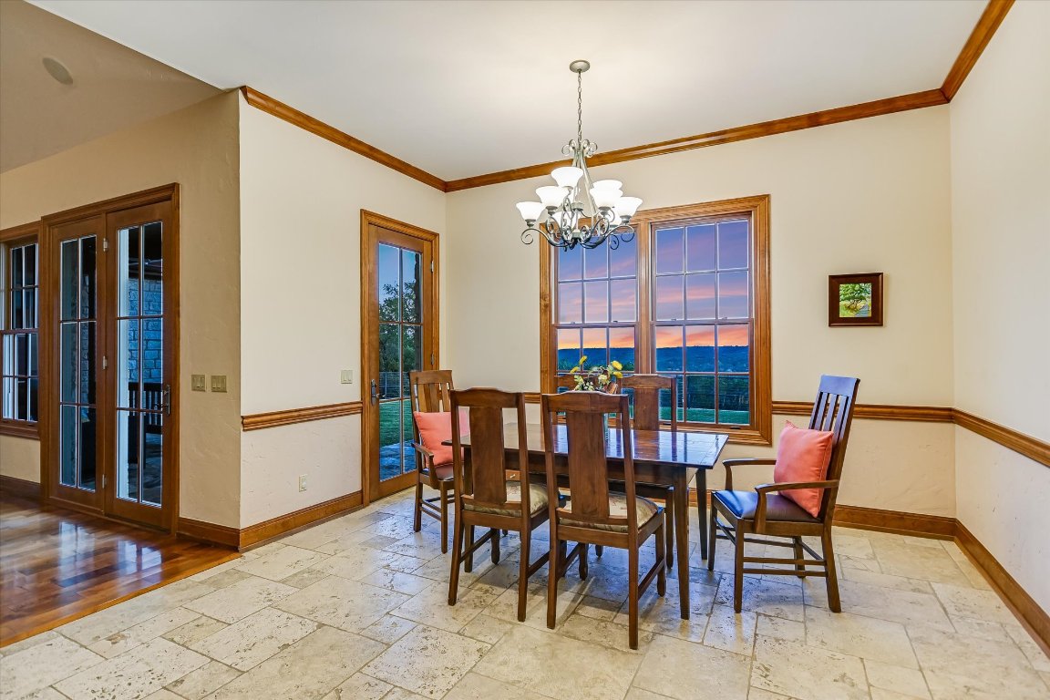 1050 River Mountain Road, Unit A Wimberley, TX 78676 - Photo 12 of 40 a view of a dining room with furniture and chandelier