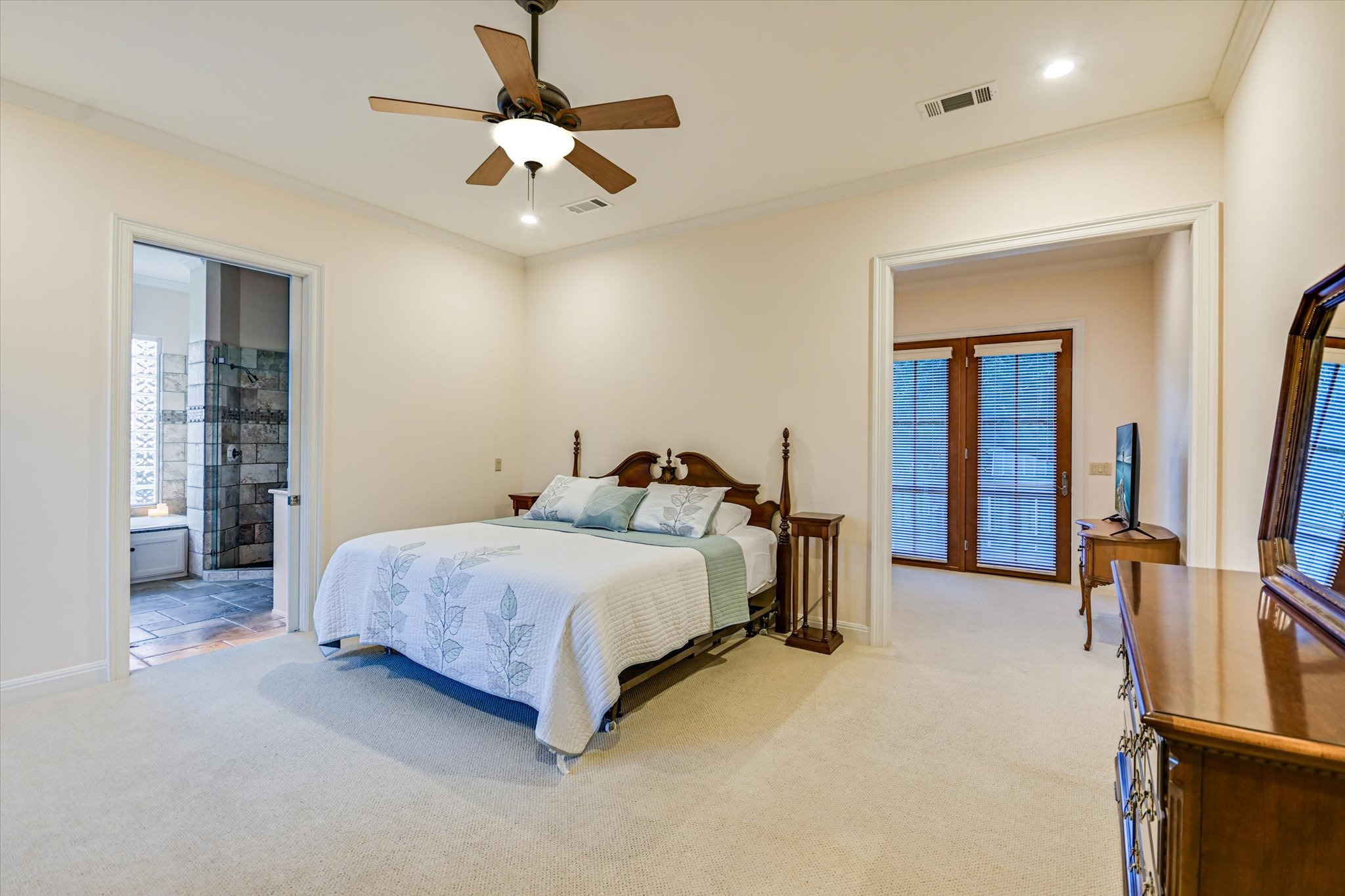 1050 River Mountain Road, Unit A Wimberley, TX 78676 - Photo 13 of 40 a spacious bedroom with a bed and a chandelier