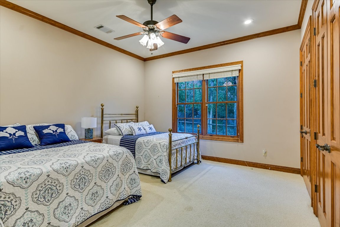 1050 River Mountain Road, Unit A Wimberley, TX 78676 - Photo 17 of 40 a bedroom with two beds and a chandelier