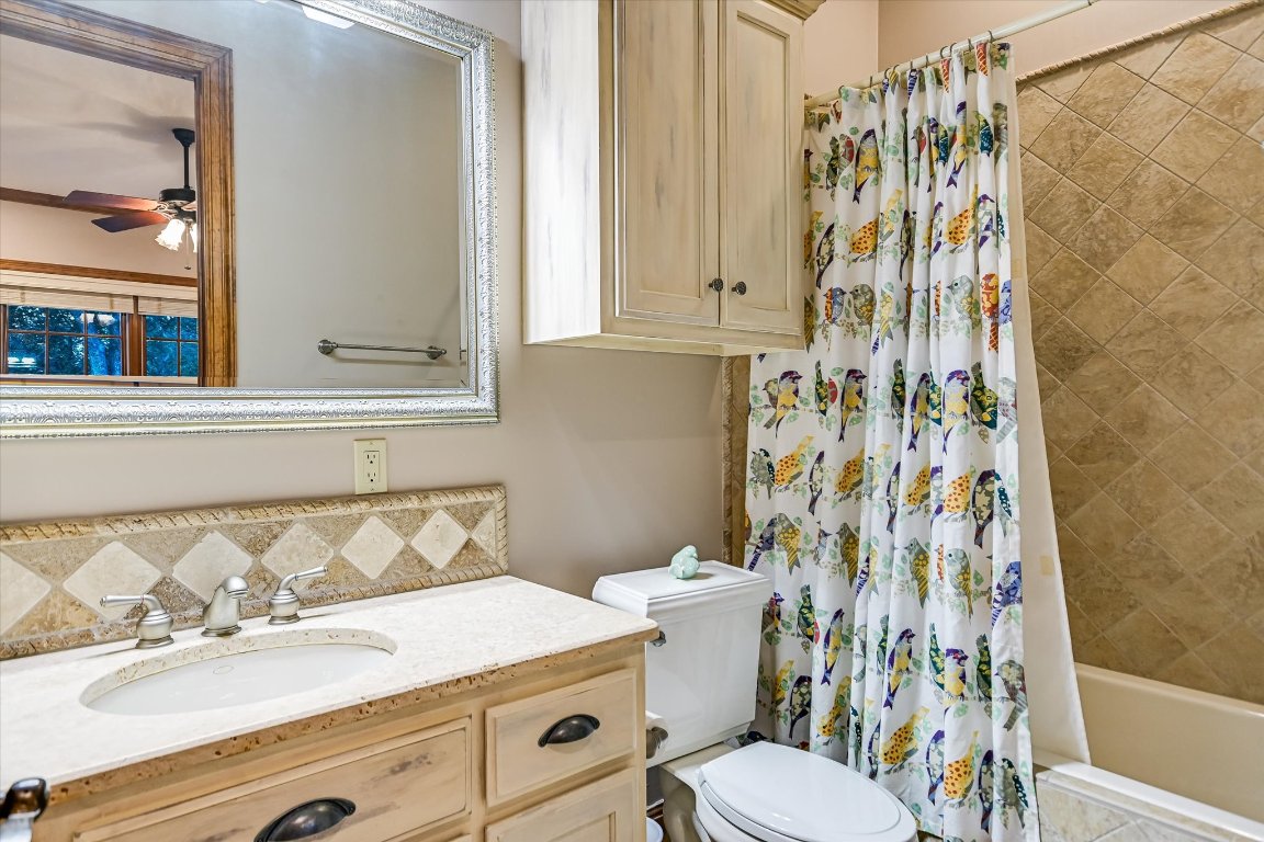 1050 River Mountain Road, Unit A Wimberley, TX 78676 - Photo 18 of 40 a bathroom with a sink a toilet and a mirror