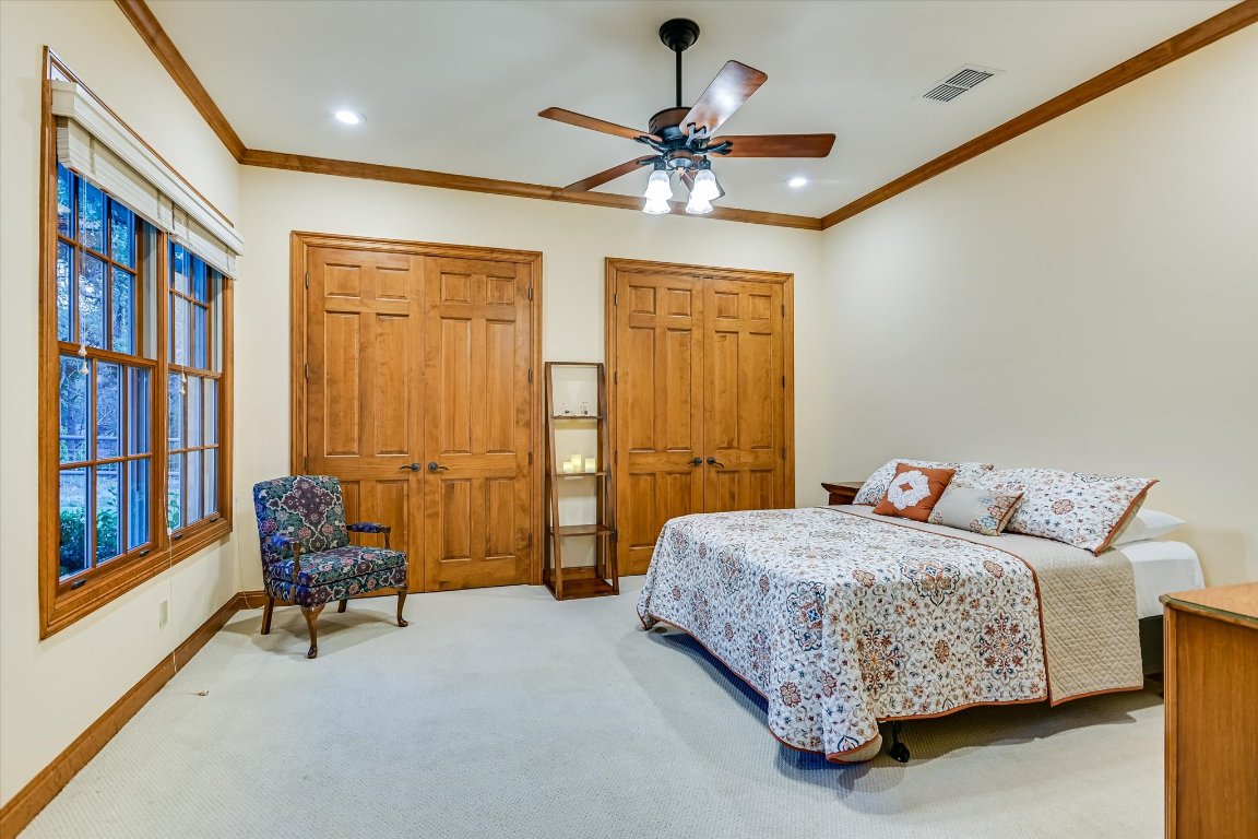 1050 River Mountain Road, Unit A Wimberley, TX 78676 - Photo 19 of 40 a bedroom with a bed and a chandelier