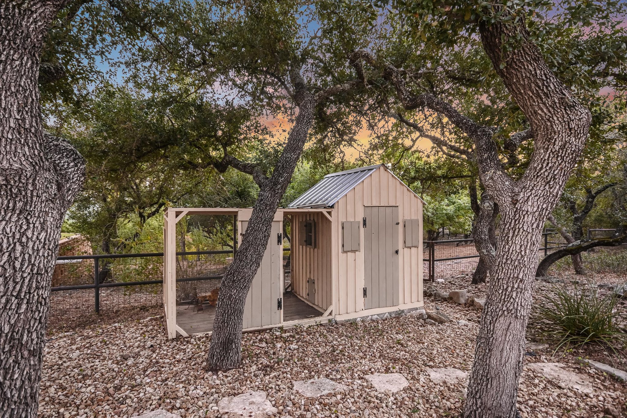 1050 River Mountain Road, Unit A Wimberley, TX 78676 - Photo 28 of 40 a view of a wooden house with a yard and large tree