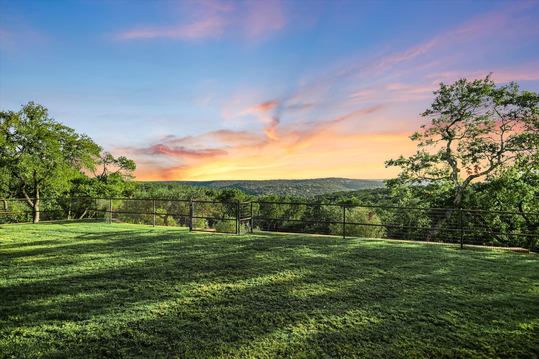 1050 River Mountain Road, Unit A Wimberley, TX 78676 - Photo 31 of 40 a view of a grassy field with trees
