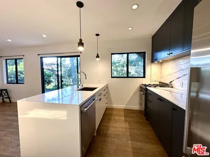 a kitchen with counter top space and stainless steel appliances