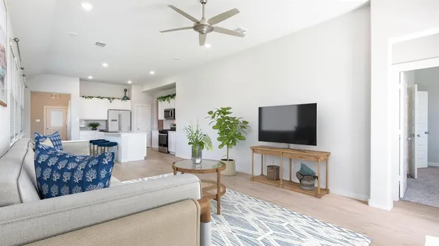 a living room with furniture a fireplace and a flat screen tv