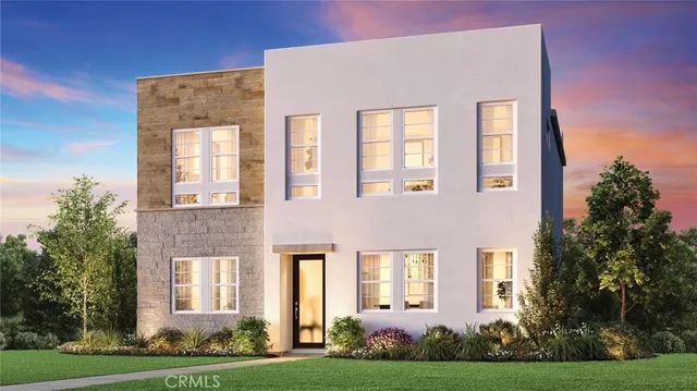 a front view of a brick building next to a yard