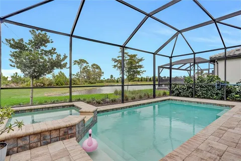 a swimming pool with yard in the back