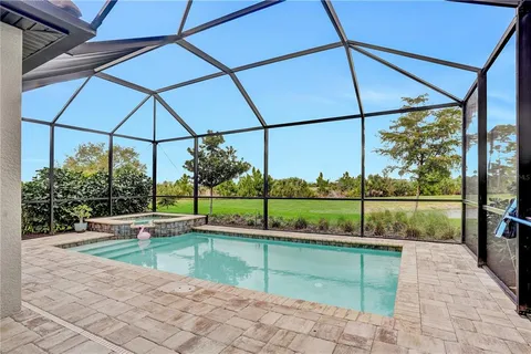 a swimming pool with outdoor seating and yard