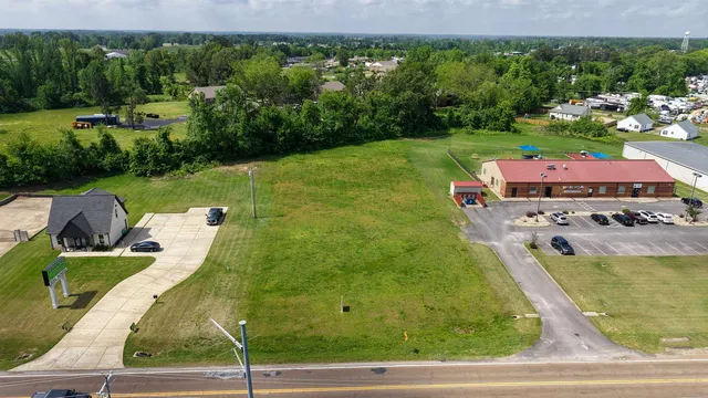 an aerial view of a house with yard patio and outdoor seating