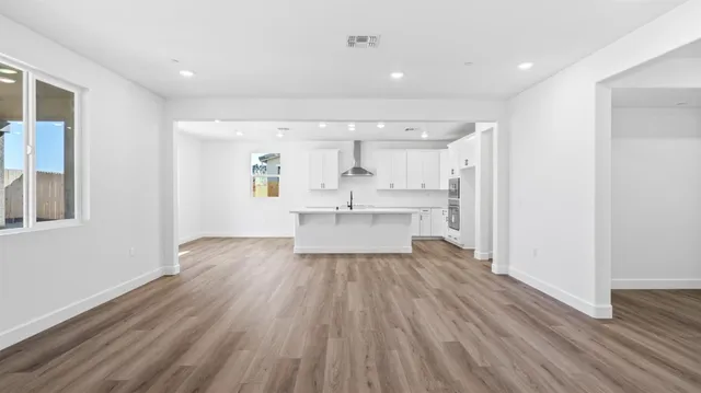 a view of a kitchen with wooden floor and a kitchen