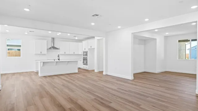 a view of kitchen with wooden floor and windows