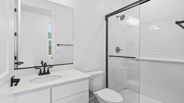 a bathroom with a sink toilet and shower