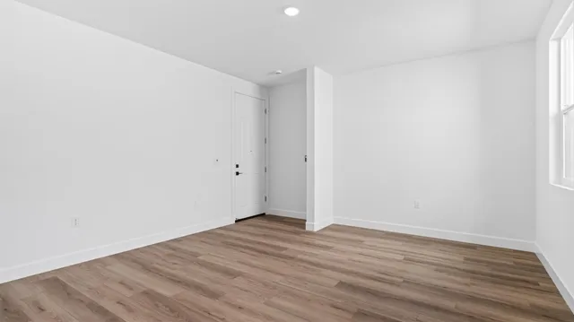 a view of room with wooden floor