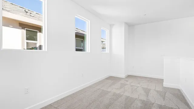 a view of a small space with wooden floor and a window