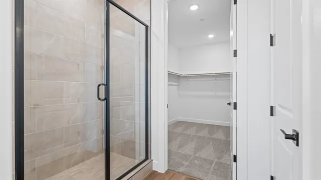 a bathroom with a glass shower door