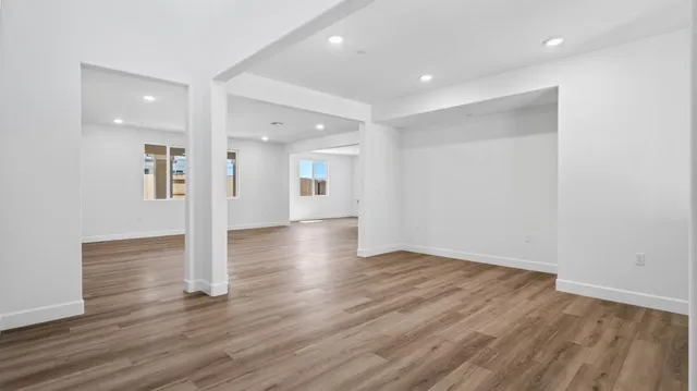 a view of a hallway with wooden floor