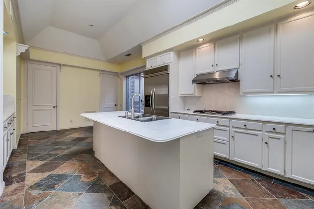a kitchen with stainless steel appliances granite countertop a sink and cabinets