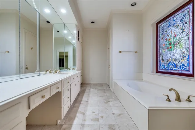 a spacious bathroom with a double vanity sink and a bathtub