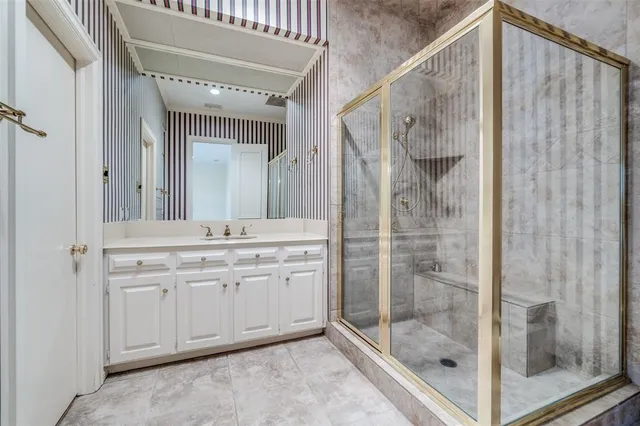 a bathroom with a shower and a sink