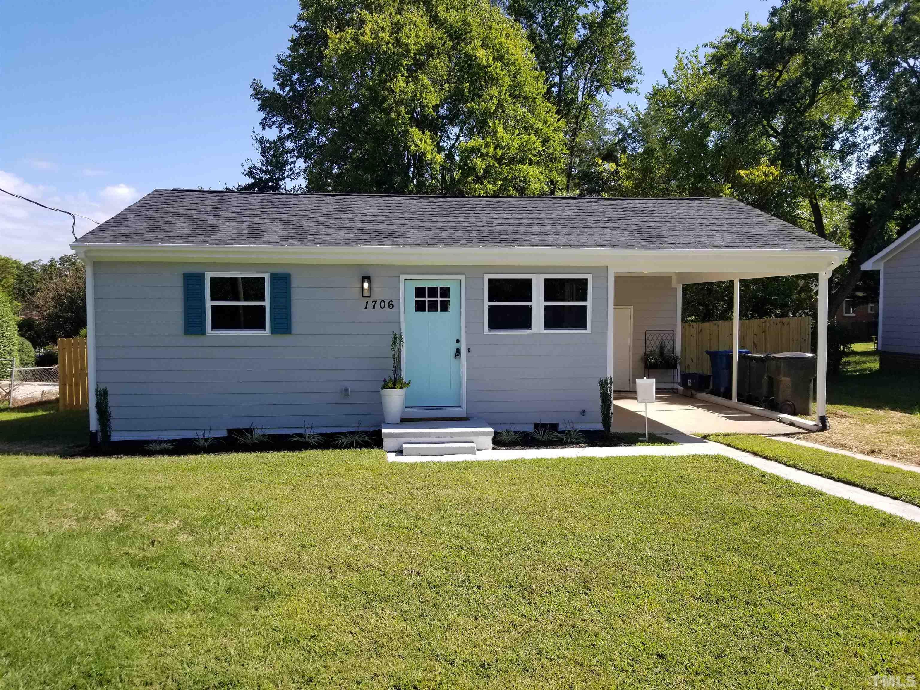 a backyard of a house with yard and outdoor seating