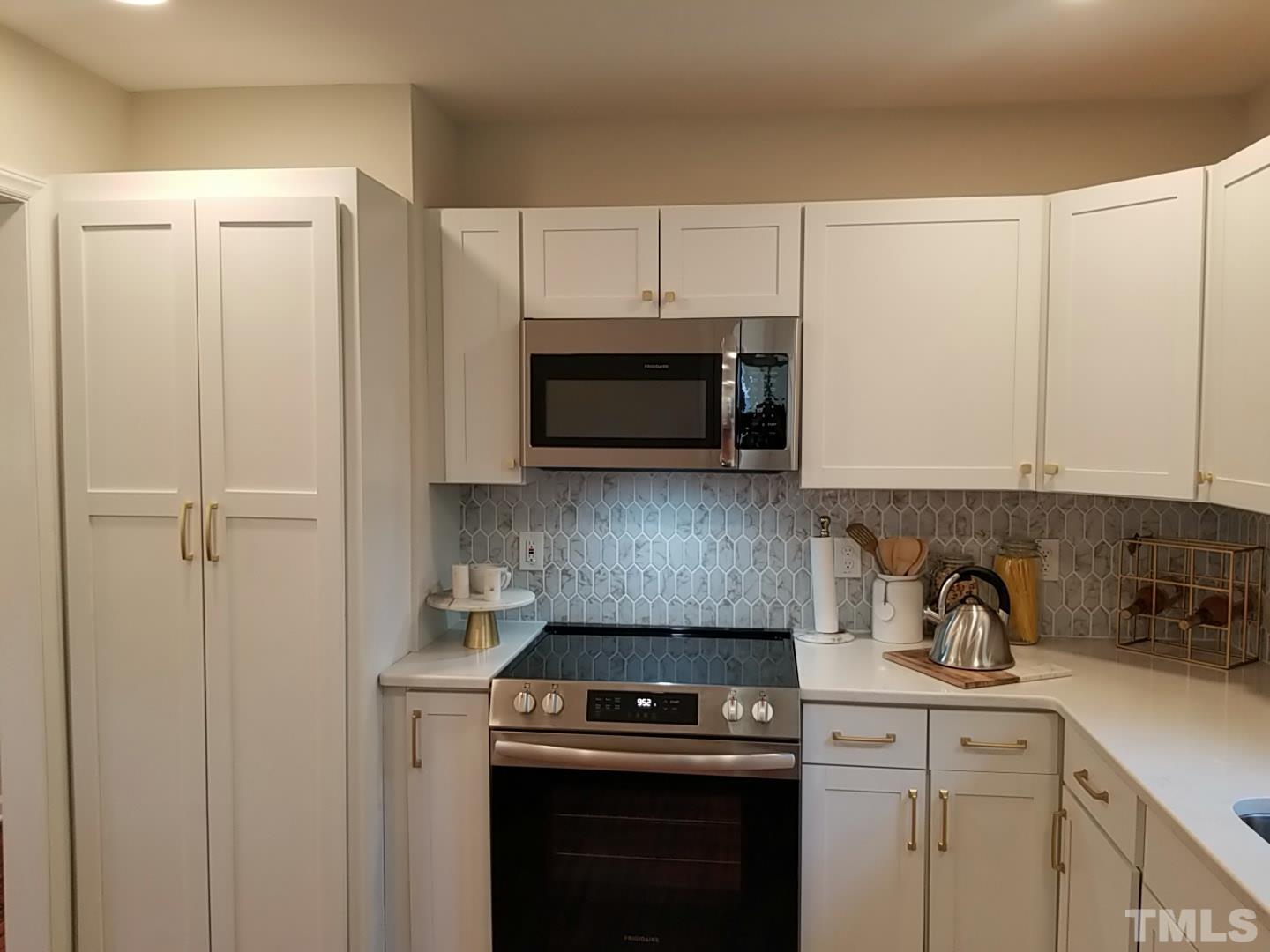1706 Capps Street Durham, NC 27707 - Photo 16 of 31 a kitchen with a stove and a microwave