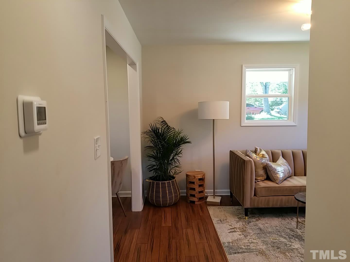 1706 Capps Street Durham, NC 27707 - Photo 17 of 31 a living room with furniture and a potted plant