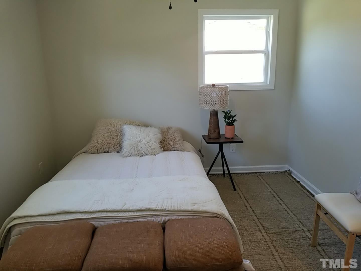 1706 Capps Street Durham, NC 27707 - Photo 18 of 31 a bedroom with a bed and window