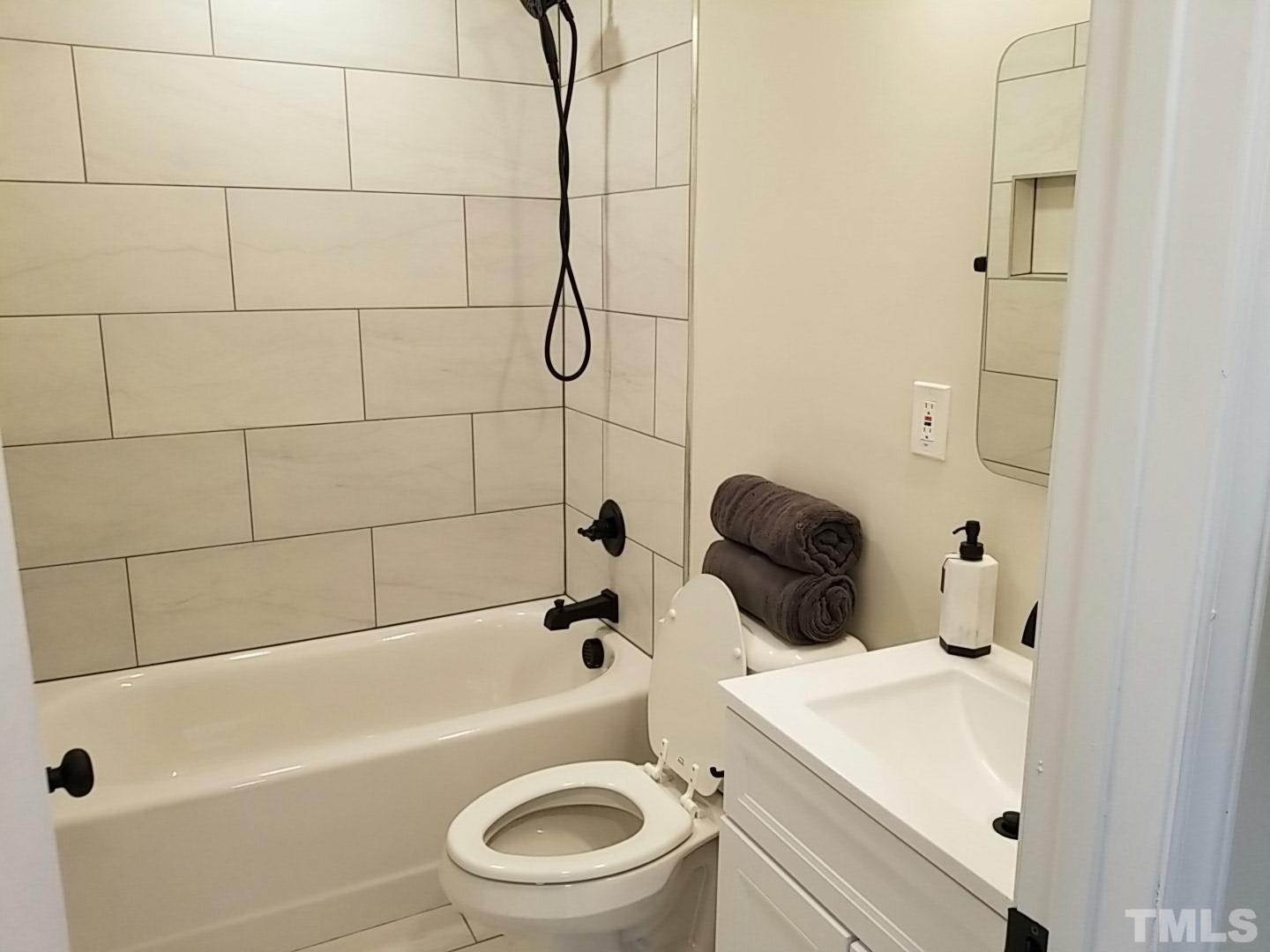 1706 Capps Street Durham, NC 27707 - Photo 20 of 31 a bathroom with a sink a toilet and a bathtub