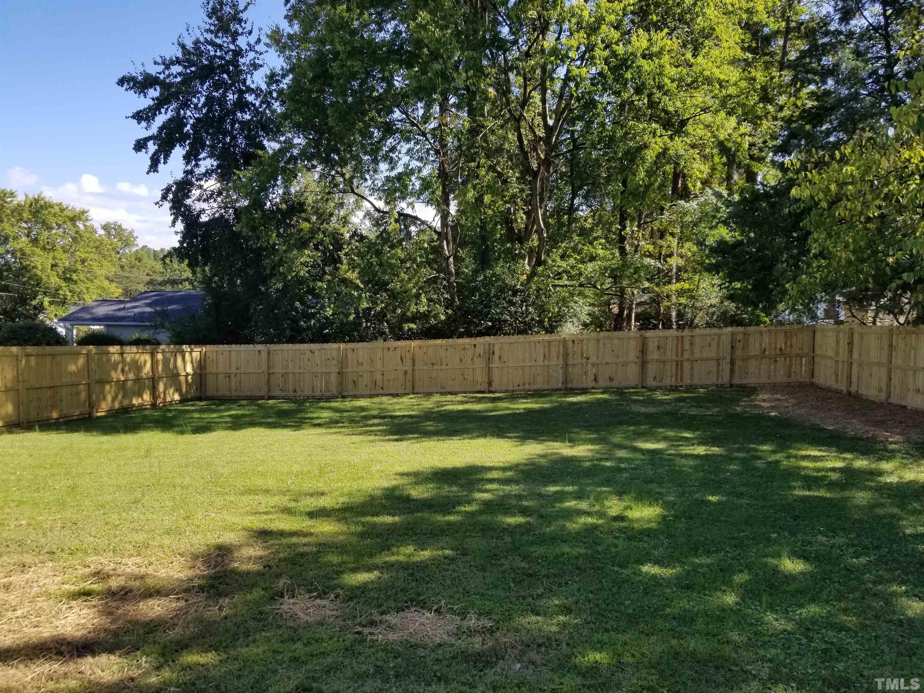1706 Capps Street Durham, NC 27707 - Photo 23 of 31 a view of a backyard with green space