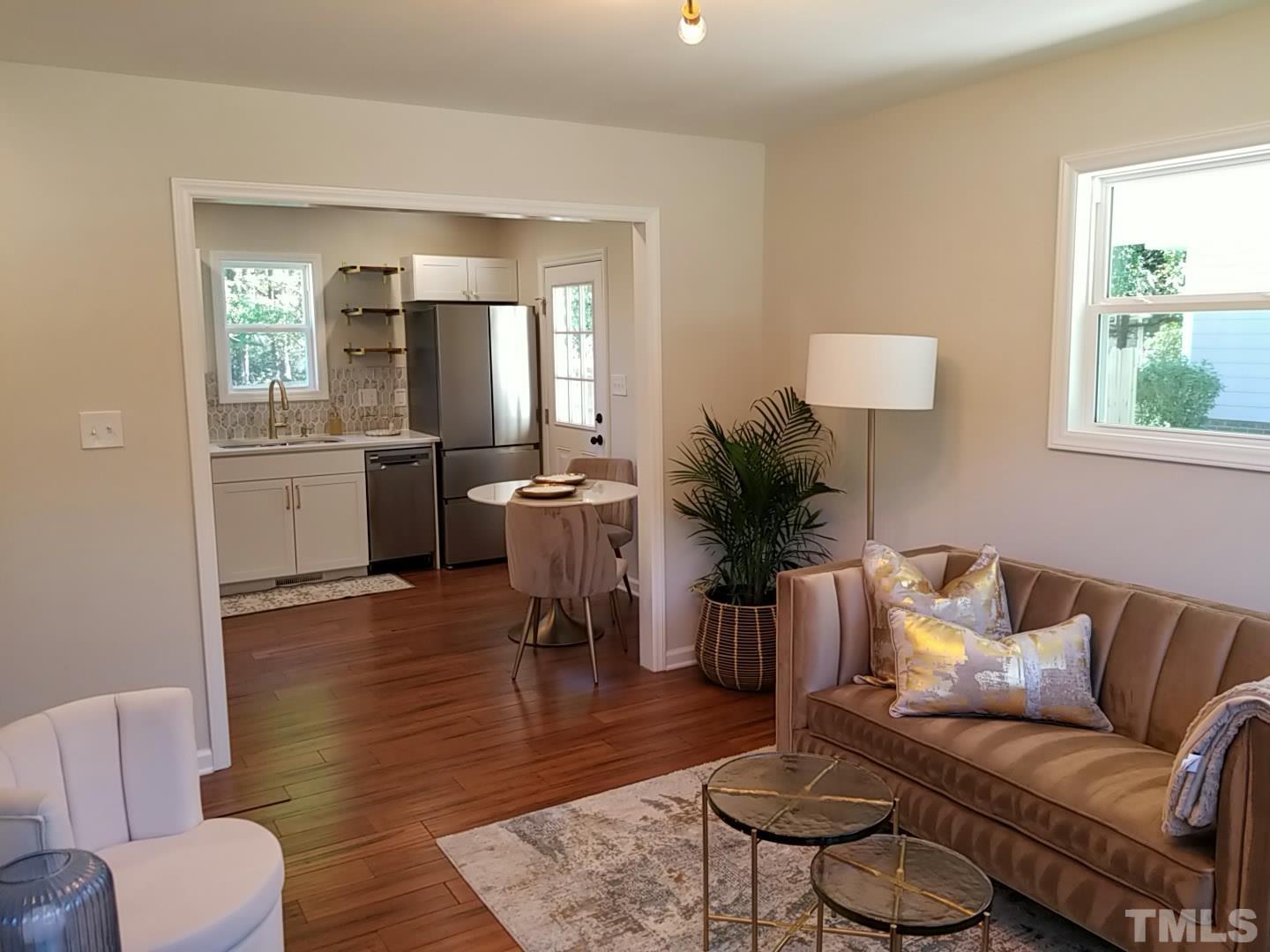 1706 Capps Street Durham, NC 27707 - Photo 6 of 31 a living room with furniture and a wooden floor