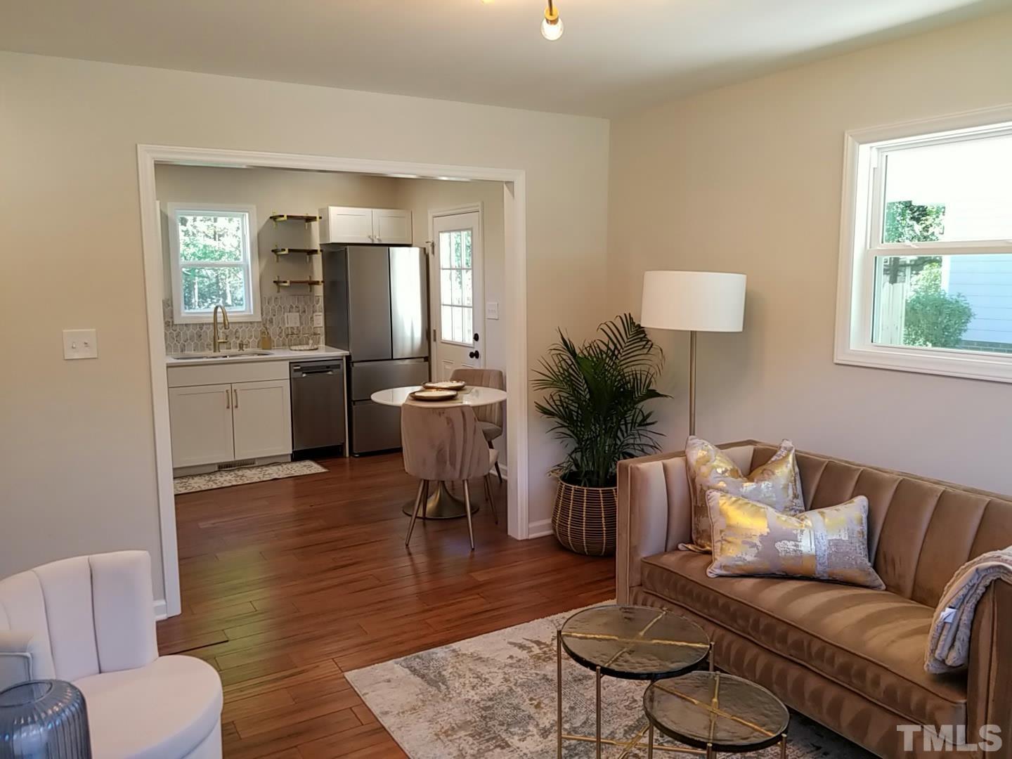 1706 Capps Street Durham, NC 27707 - Photo 7 of 31 a living room with furniture wooden floor and a table