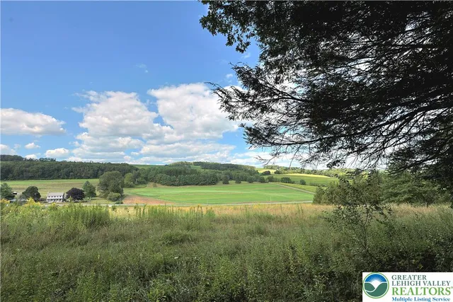 a view of a lake with houses in the back