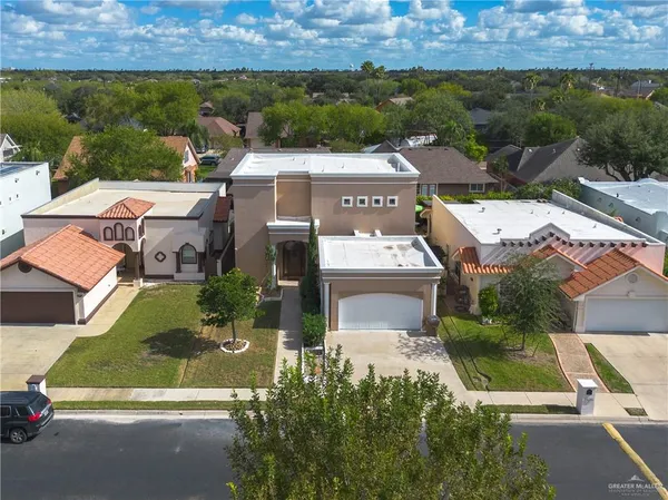 an aerial view of a house with a garden and lake view