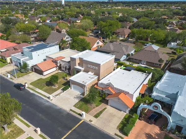 an aerial view of residential house with parking space and city view