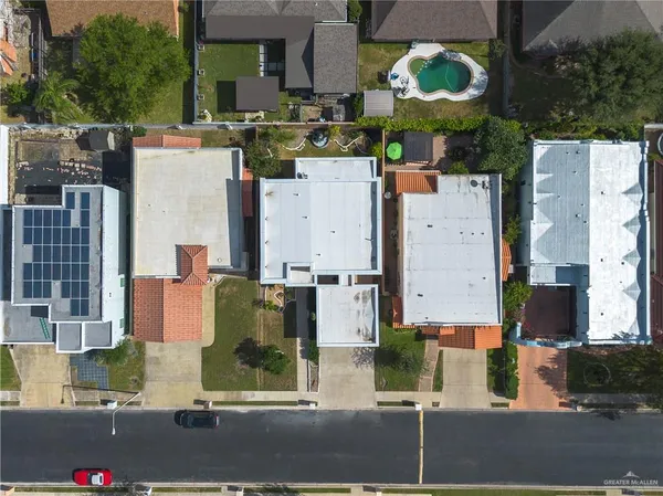 an aerial view of residential houses with outdoor space