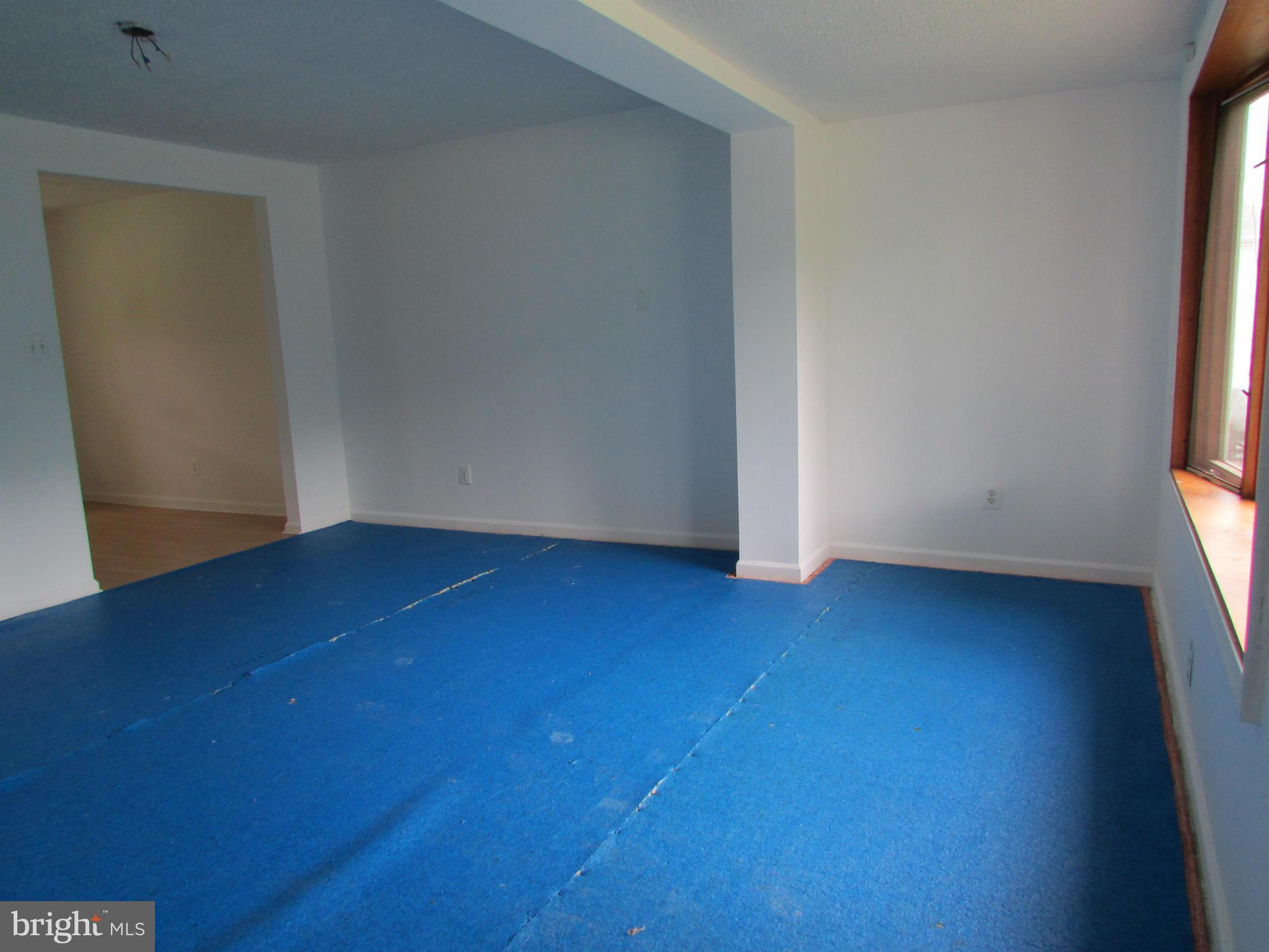600 Meadow Road Baltimore, MD 21206 - Photo 3 of 13 an empty room with wooden floor and windows