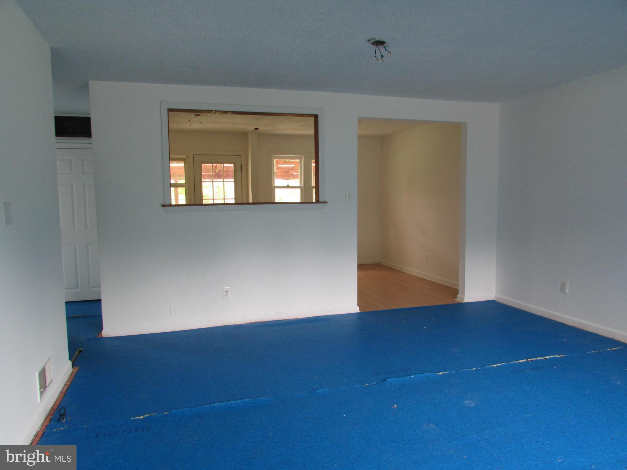 600 Meadow Road Baltimore, MD 21206 - Photo 4 of 13 an empty room with wooden floor and windows