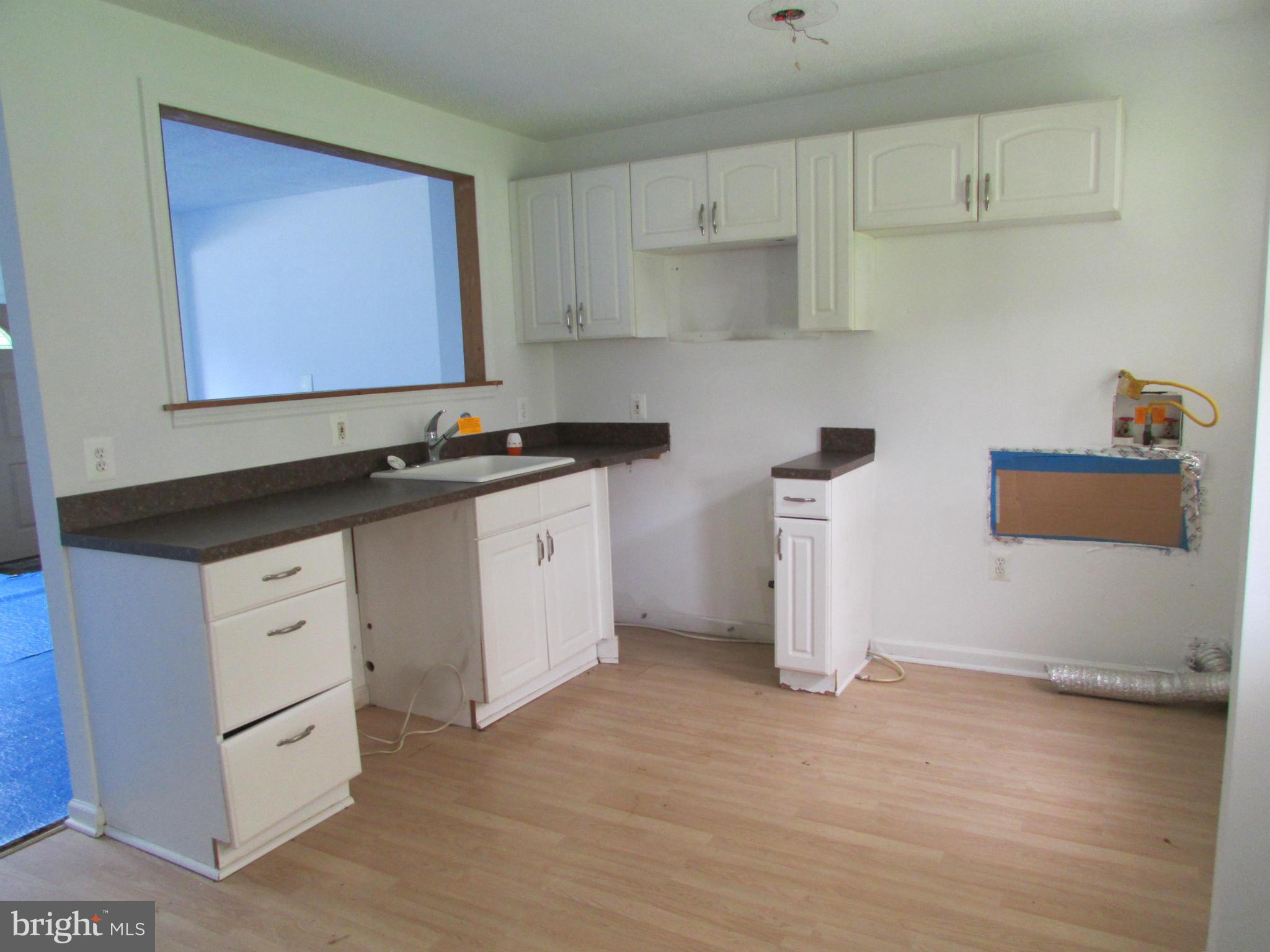 600 Meadow Road Baltimore, MD 21206 - Photo 5 of 13 a kitchen with white cabinets and sink