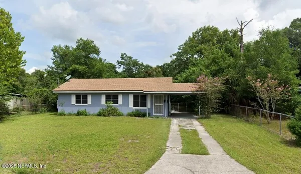 a front view of house with yard and green space