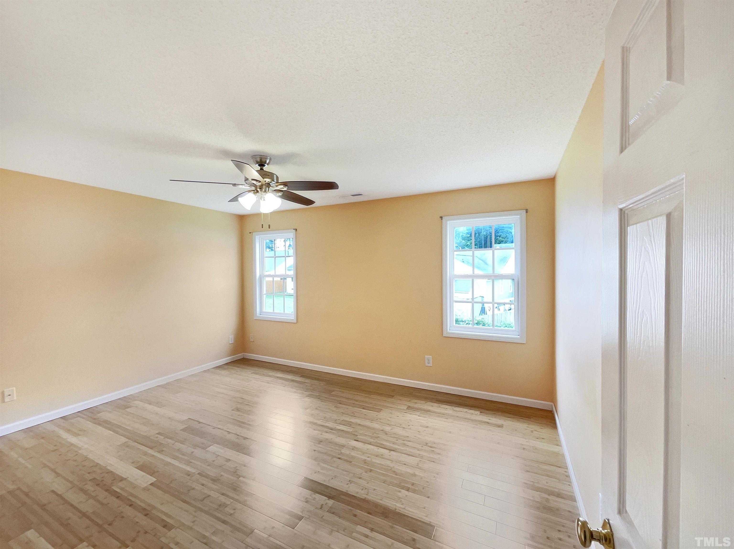 5720 Tealbrook Drive Raleigh, NC 27610 - Photo 11 of 17 a view of an empty room with window and wooden floor