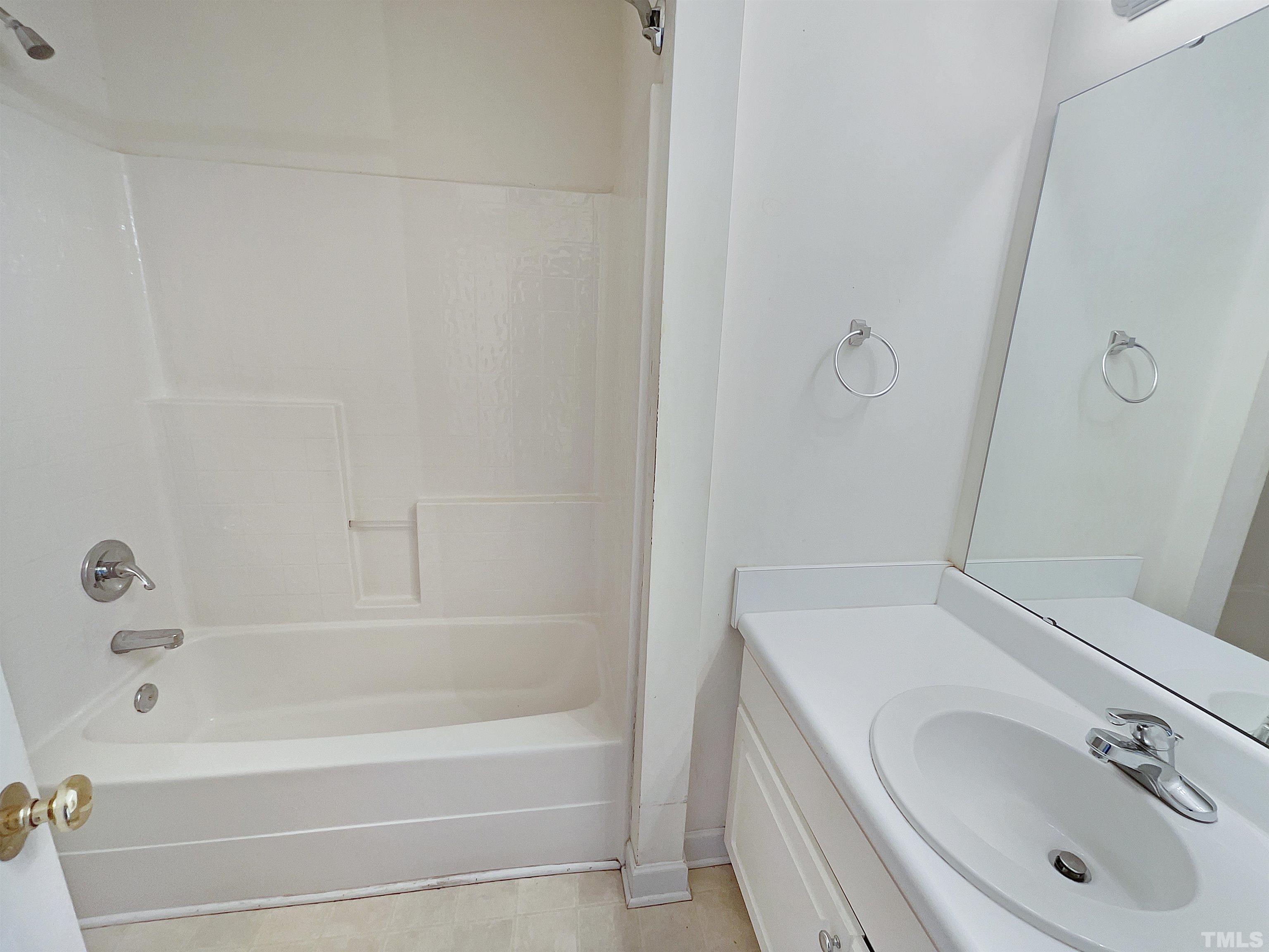 5720 Tealbrook Drive Raleigh, NC 27610 - Photo 13 of 17 a bathroom with a tub sink and mirror