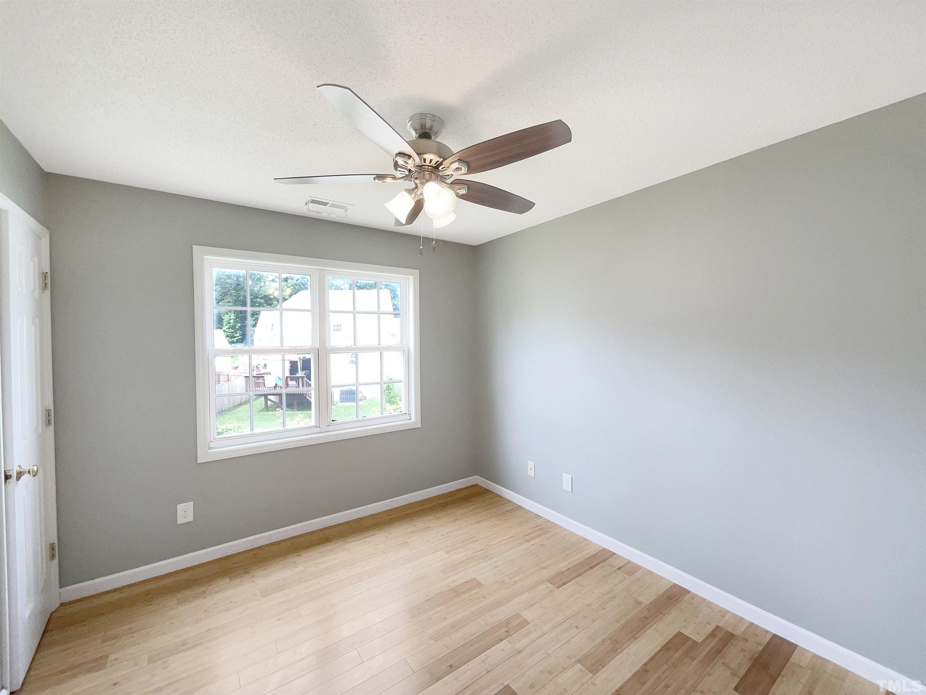 5720 Tealbrook Drive Raleigh, NC 27610 - Photo 9 of 17 an empty room with a window and a fan
