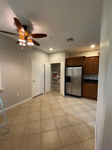 a view of a kitchen with a sink and a refrigerator