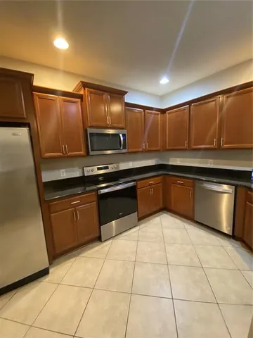 a kitchen with stainless steel appliances granite countertop a sink and cabinets