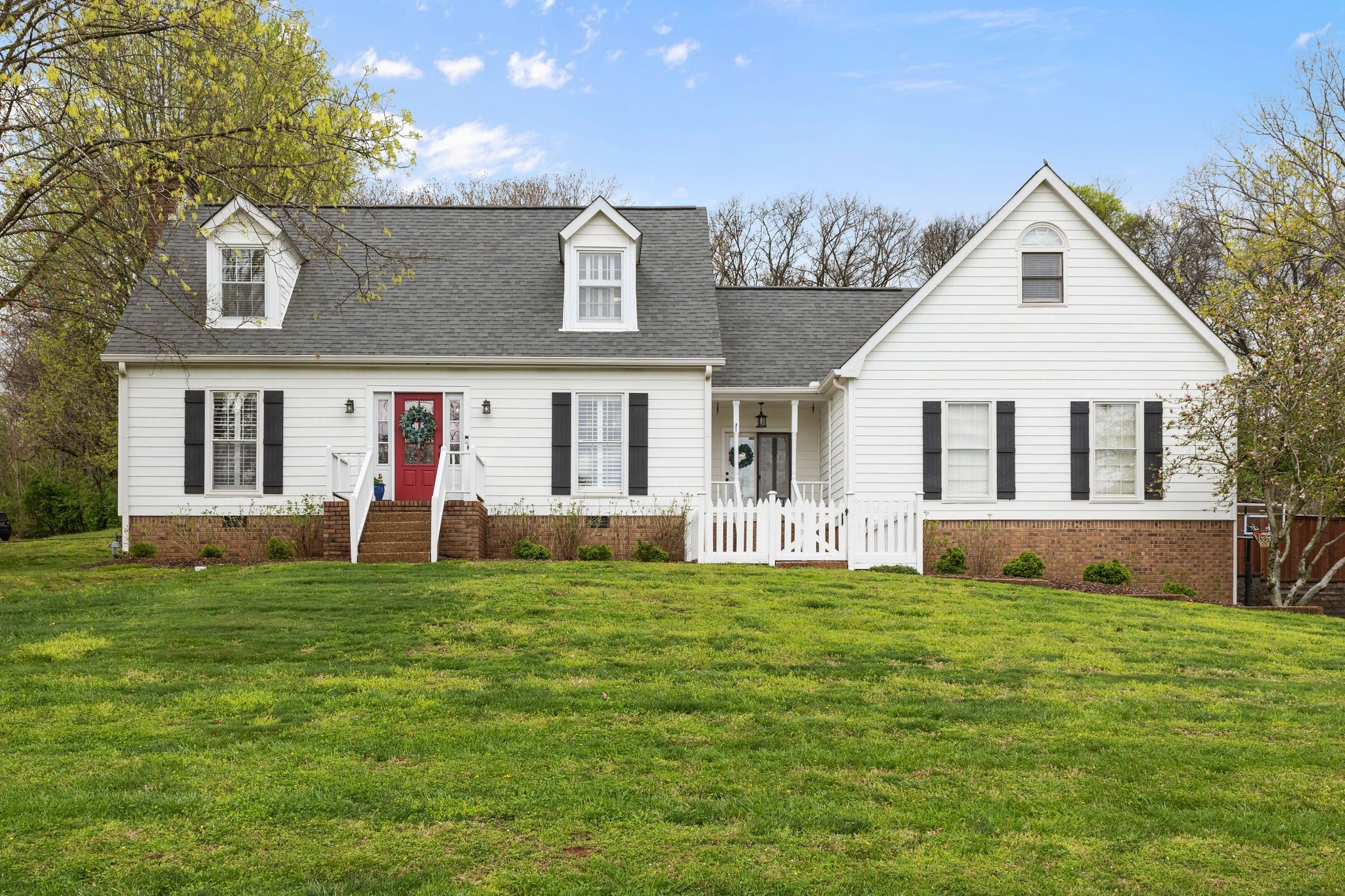 a front view of house with yard and green space