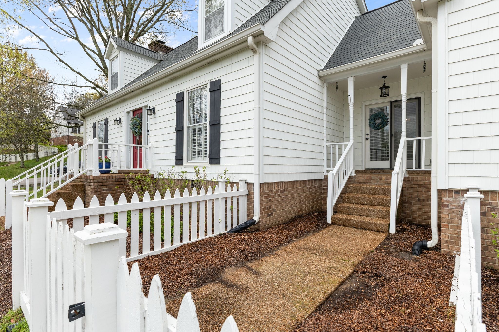 1517 Pinkerton Road Brentwood, TN 37027 - Photo 4 of 49 a view of a house with wooden fence and a porch