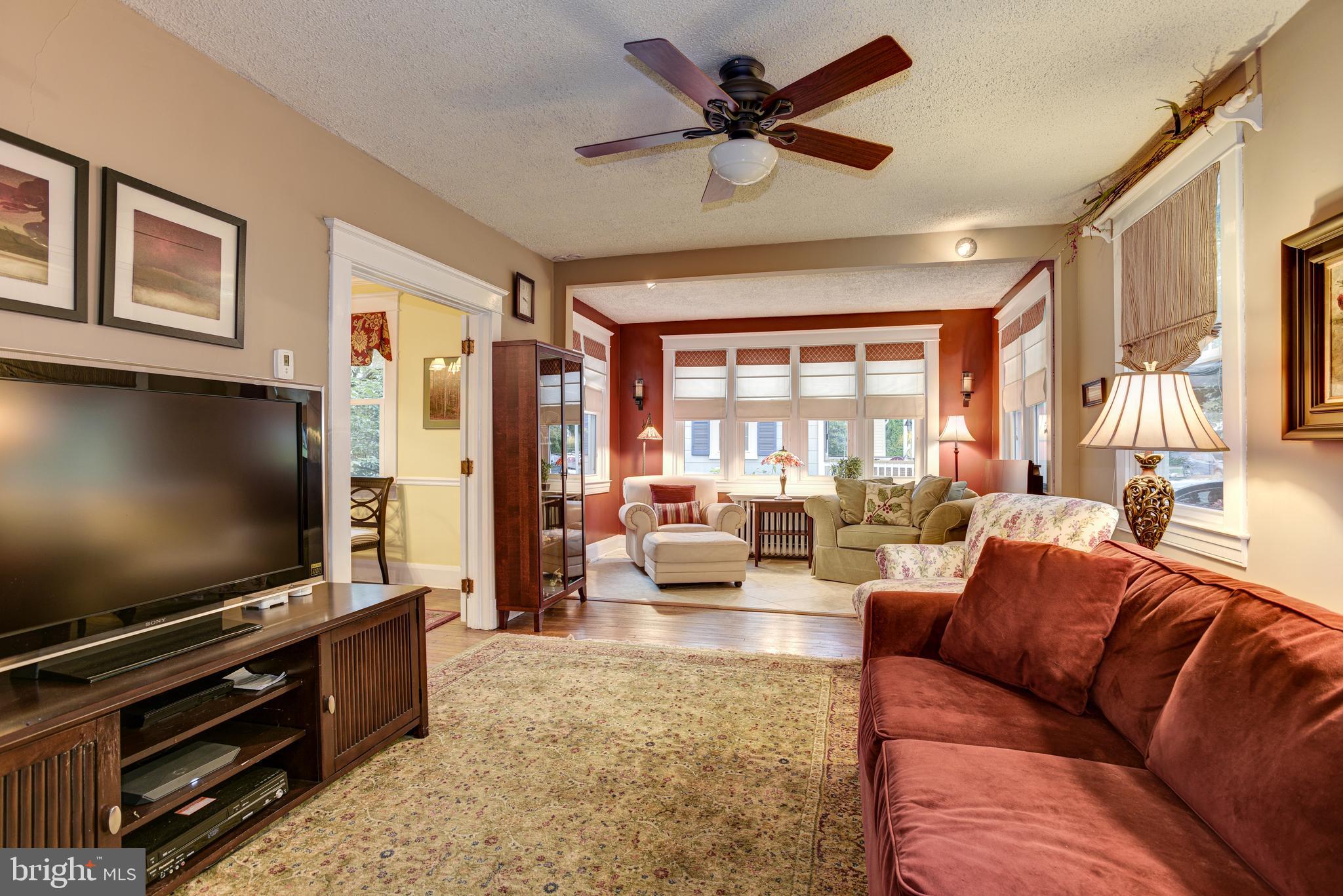 711 Murdock Road Baltimore, MD 21212 - Photo 13 of 49 Living room plus sun room across front of house
