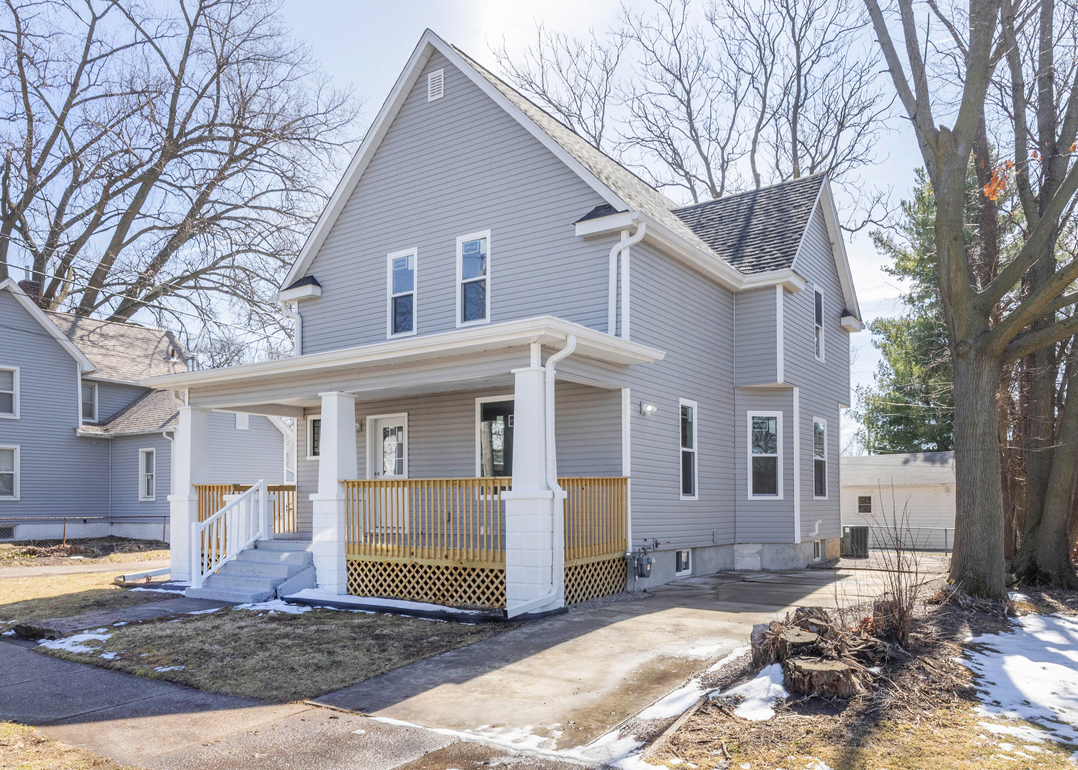 a front view of a house with a yard covered in snow
