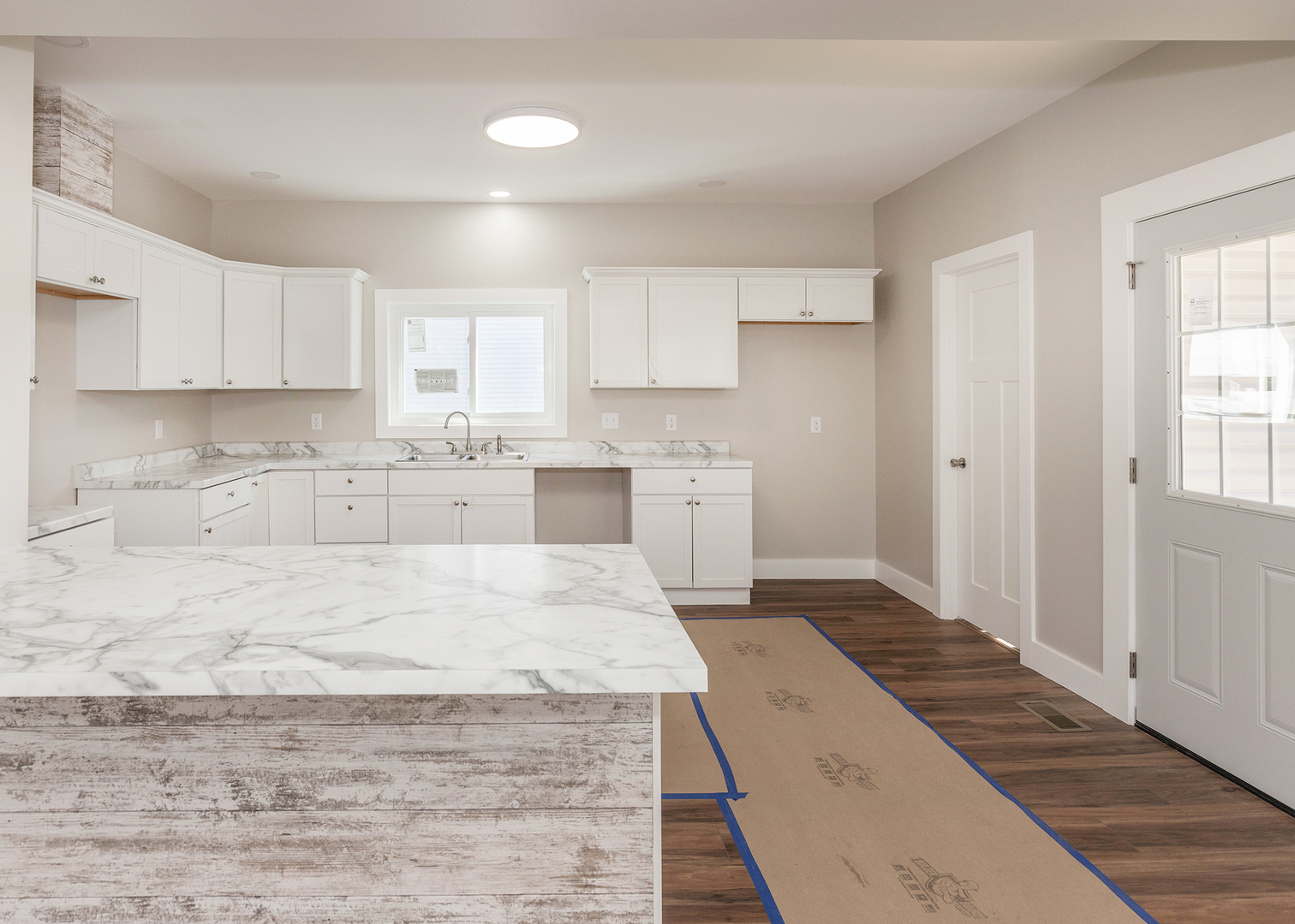 1212 14th Avenue Moline, IL 61265 - Photo 12 of 32 a large white kitchen with kitchen island a sink stainless steel appliances and cabinets