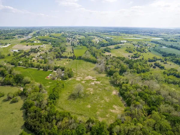 a view of a city with lush green forest